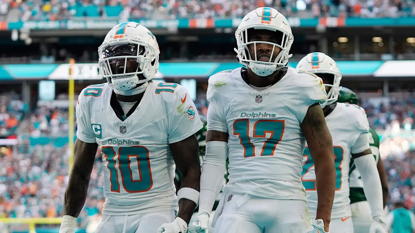 Miami Dolphins wide receiver Jaylen Waddle (17) and wide receiver Tyreek Hill (10) celebrate a touchdown and a two-point conversion during the second half of an NFL football game against the New York Jets in Miami Gardens, Florida, on Dec. 8, 2024. (AP Photo/Wilfredo Lee)