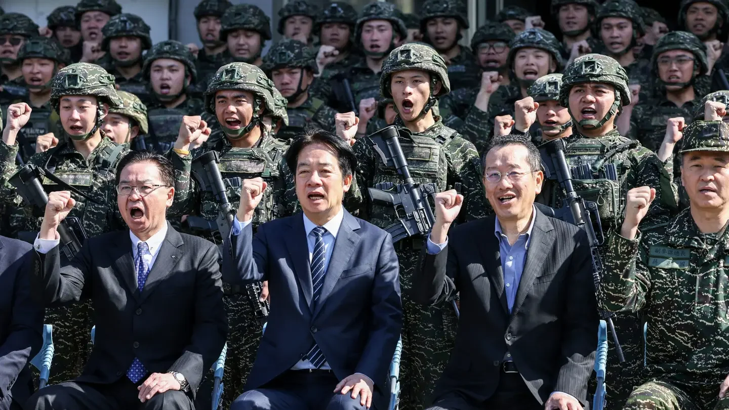 Taiwan's National Security Council Secretary-General Joseph Wu, Taiwan's President William Lai and Taiwan's Defense Minister Wellington Koo pose for photos with soldiers as they visit the troops. (I-HWA CHENG/AFP via Getty Images)