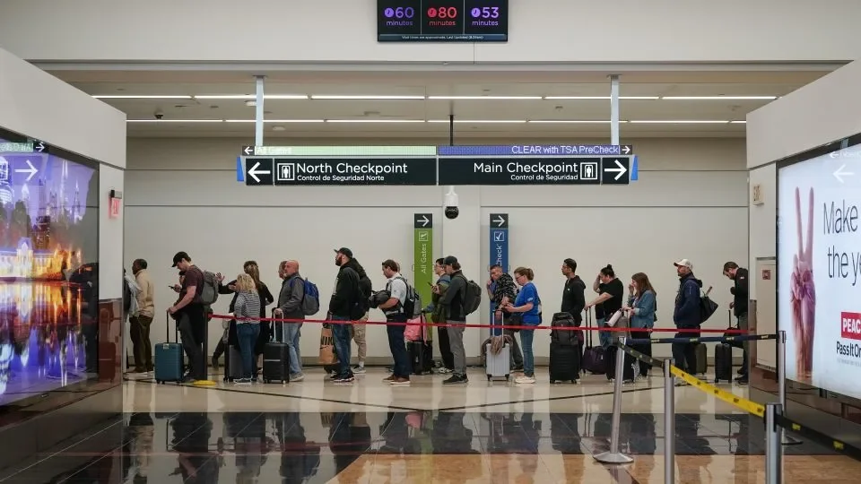 Travelers wait in line at a Transportation Security Administration checkpoint at Hartsfield-Jackson Atlanta International Airport in Georgia, on Friday. - Elijah Nouvelage/Bloomberg/Getty Images
