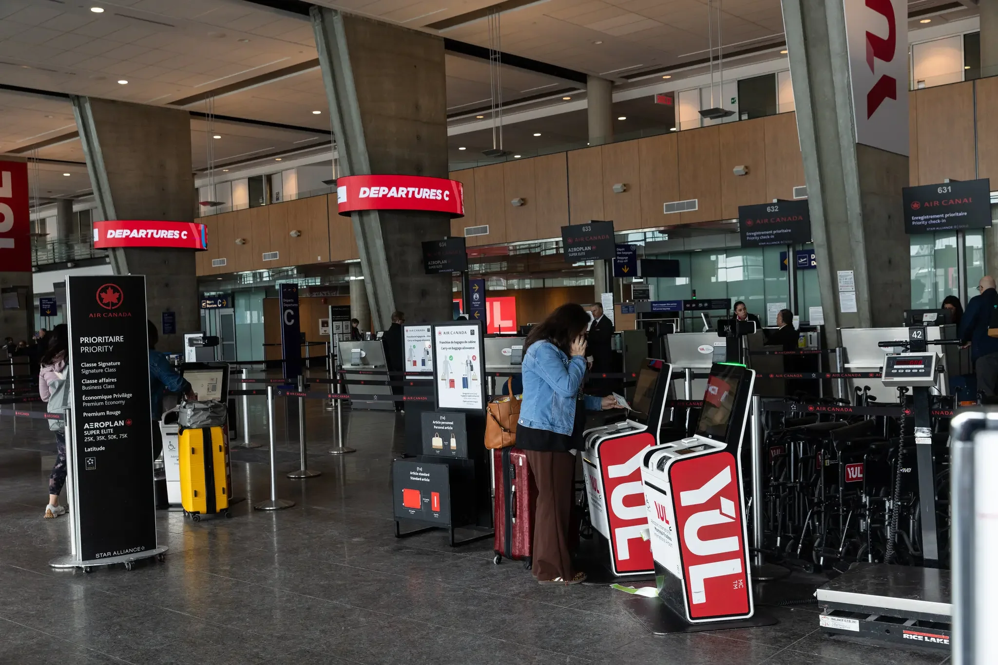 A passenger checking in at Air Canada’s departures area in Montreal-Pierre Elliott Trudeau Airport in Montreal, Quebec, on Monday.Credit...Nasuna Stuart-Ulin for The New York Times