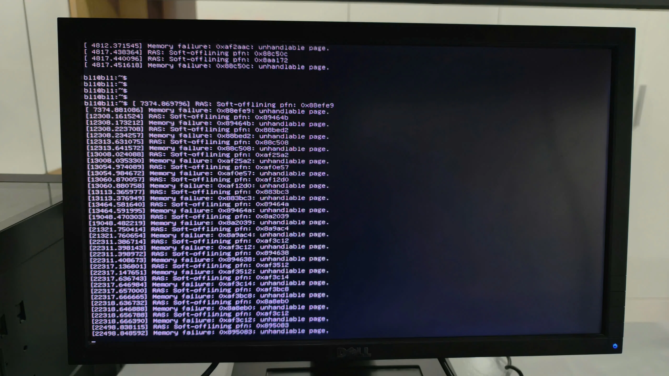 A full-screen view of a Dell monitor showing a continuous scroll of hardware-level errors in a Linux environment. The logs repeat 'Memory failure' and 'unhandled page' messages for various memory addresses (PFNs), indicating a severe RAM hardware issue or system instability.