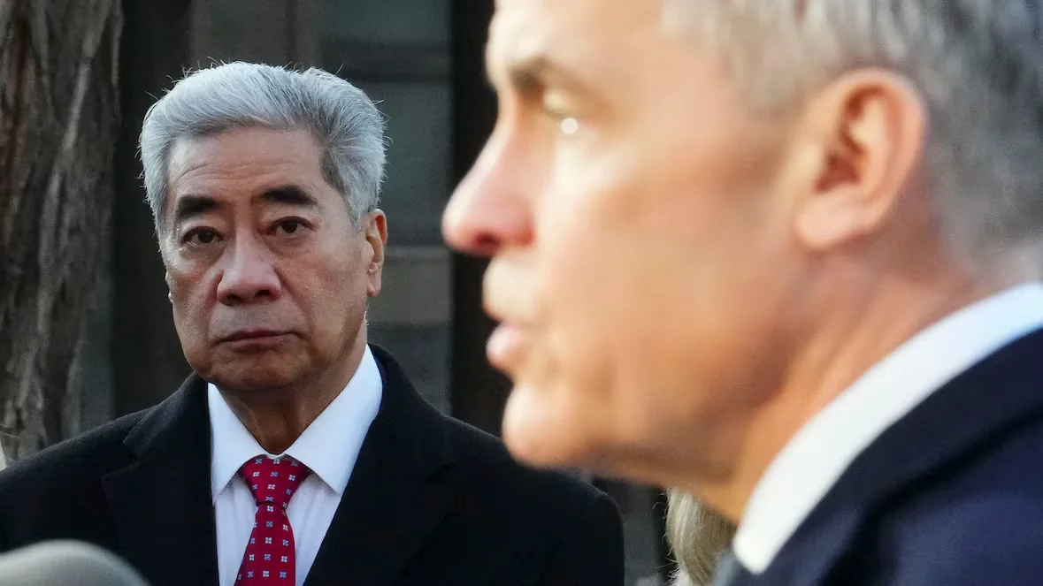 Liberal member of Parliament Michael Ma looks on as Prime Minister Mark Carney holds a news conference earlier this year. Ma joined the government side of the House in December. (Sean Kilpatrick/The Canadian Press)