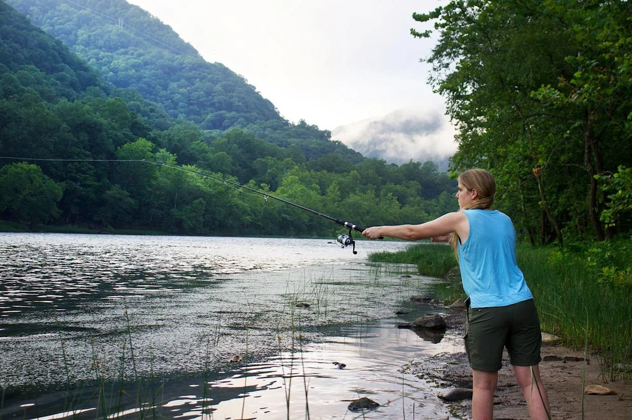 A woman fishing in the New River. Credit: Jordan Charbonneau/Travel + Leisure