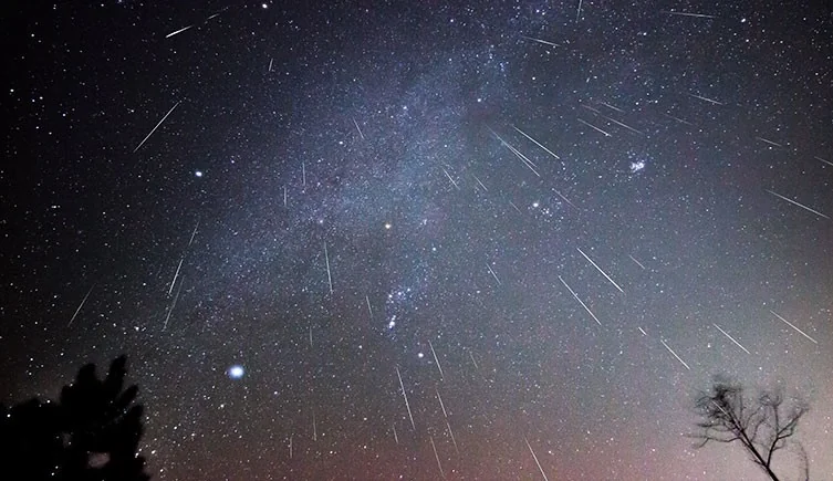 A meteor shower and the Milky Way in a composite image taken over several hours. © Genevieve de Messieres/ Shutterstock