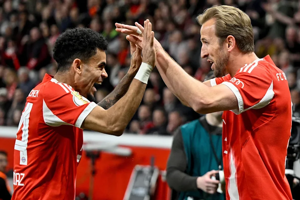 TOPSHOT - Bayern Munich's English forward #09 Harry Kane celebrates scoring the opening goal with his teammate Bayern Munich's Colombian forward #14 Luis Diaz during the German Cup (DFB-Pokal) semi-final football match between Bayer 04 Leverkusen and FC Bayern Munich in Leverkusen, western Germany on April 22, 2026. (Photo by INA FASSBENDER / AFP via Getty Images) / DFB REGULATIONS PROHIBIT ANY USE OF PHOTOGRAPHS AS IMAGE SEQUENCES AND QUASI-VIDEO. | AFP via Getty Images
