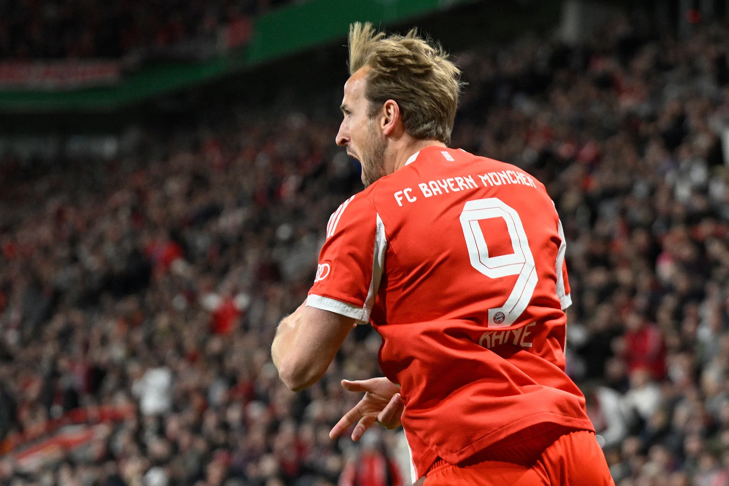 Bayern Munich's English forward #09 Harry Kane celebrates scoring the opening goal with his teammates during the German Cup (DFB-Pokal) semi-final football match between Bayer 04 Leverkusen and FC Bayern Munich in Leverkusen, western Germany on April 22, 2026. (Photo by INA FASSBENDER / AFP via Getty Images) / DFB REGULATIONS PROHIBIT ANY USE OF PHOTOGRAPHS AS IMAGE SEQUENCES AND QUASI-VIDEO. | AFP via Getty Images
