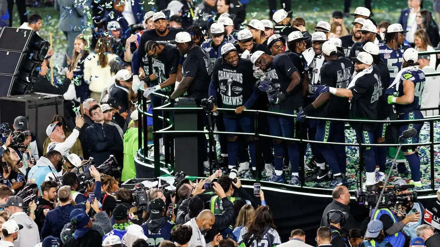 Derick Hall of the Seattle Seahawks holds the Vince Lombardi trophy on stage with his teammates after winning Super Bowl LX against the New England Patriots at Levi's Stadium in Santa Clara, Calif., on Feb. 8, 2026. (Brooke Sutton/Getty Images)