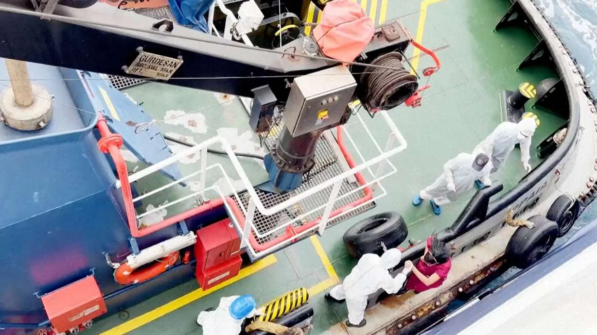 Health workers get off the Dutch-flagged MV Hondius, a cruise ship carrying nearly 150 people, as it remains off Cape Verde on Monday, after three passengers died and several others fell seriously ill in a suspected hantavirus outbreak. (Qasem Elhato via AP)