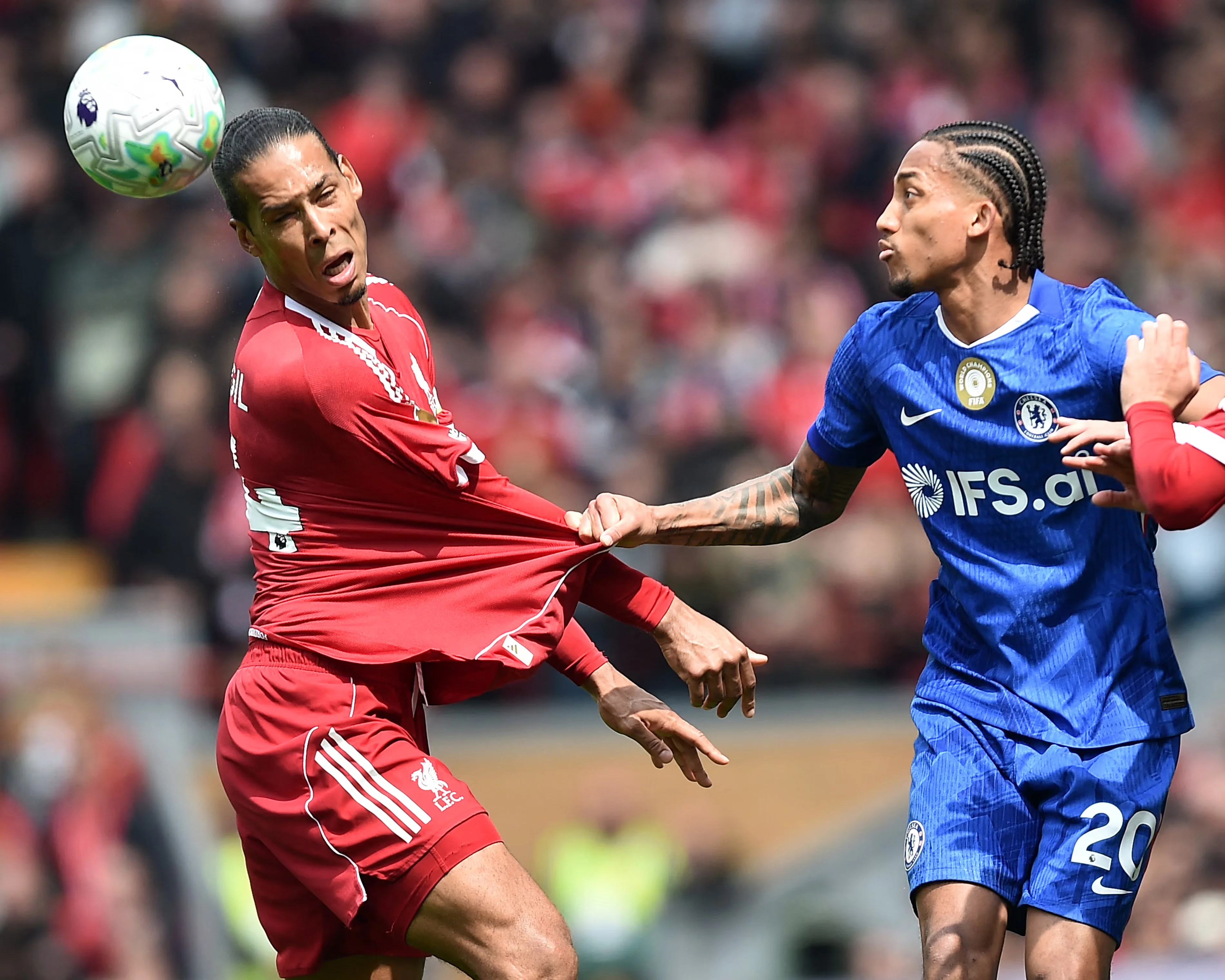 Joao Pedro has a tug at Virgil van Dijk’s jersey. Photograph: Peter Powell/AFP/Getty Images